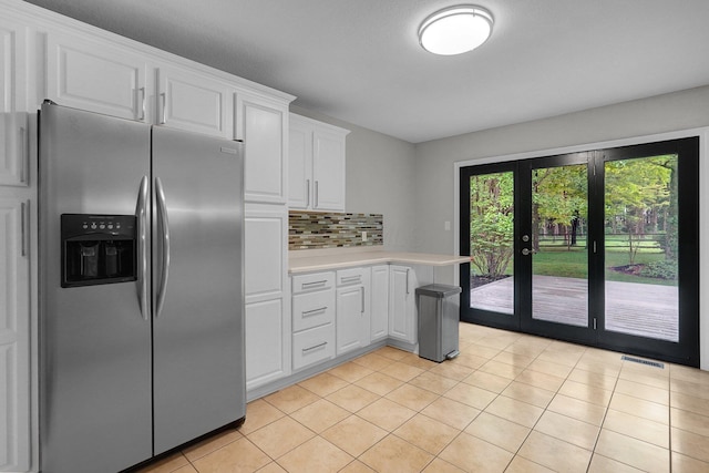 6233 Coonpath Rd NW, Carroll, OH 43112 - kitchen featuring stainless steel fridge with ice dispenser, light countertops, light tile patterned floors, white cabinets, and tasteful backsplash