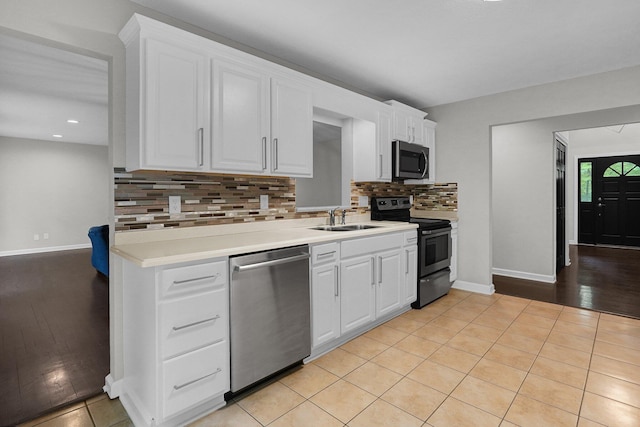 6233 Coonpath Rd NW, Carroll, OH 43112 - kitchen with stainless steel appliances, tasteful backsplash, white cabinetry, light countertops, and recessed lighting