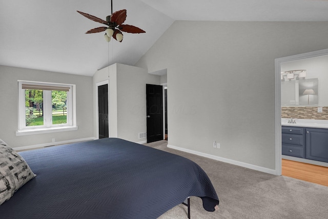 6233 Coonpath Rd NW, Carroll, OH 43112 - bedroom featuring light colored carpet, high vaulted ceiling, ensuite bath, and a ceiling fan