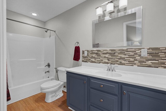 6233 Coonpath Rd NW, Carroll, OH 43112 - full bath with bathtub / shower combination, wood finished floors, tasteful backsplash, and vanity