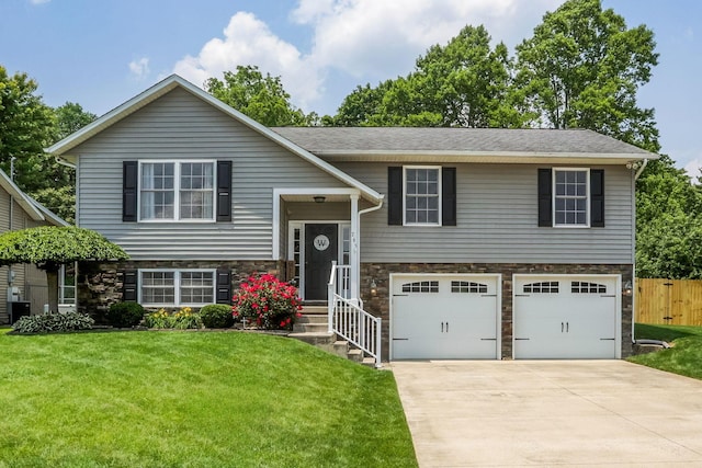 765 Huntley Ave, Logan, OH 43138 - split foyer home with stone siding, a garage, and driveway