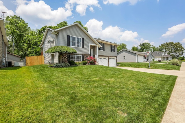 765 Huntley Ave, Logan, OH 43138 - split foyer home with an attached garage, driveway, central air condition unit, and stone siding