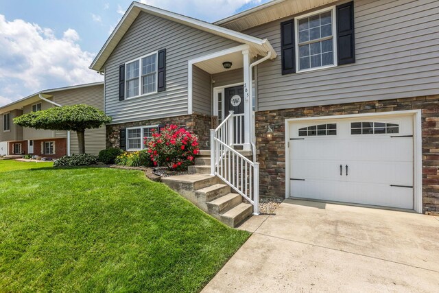 765 Huntley Ave, Logan, OH 43138 - split foyer home with stone siding, a garage, a front yard, and concrete driveway