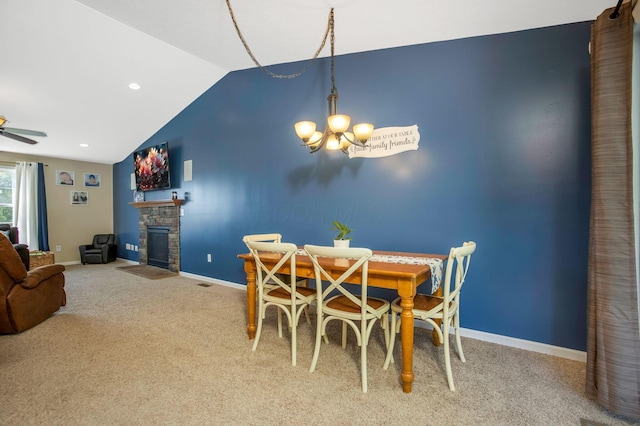 765 Huntley Ave, Logan, OH 43138 - carpeted dining area with vaulted ceiling, baseboards, a chandelier, a stone fireplace, and a ceiling fan