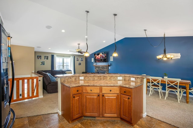 765 Huntley Ave, Logan, OH 43138 - kitchen featuring a stone fireplace, a chandelier, a ceiling fan, vaulted ceiling, and open floor plan