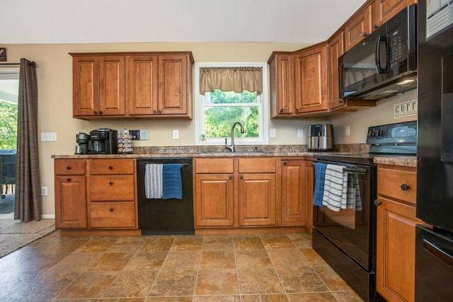 765 Huntley Ave, Logan, OH 43138 - kitchen with black appliances, a sink, brown cabinetry, and healthy amount of natural light