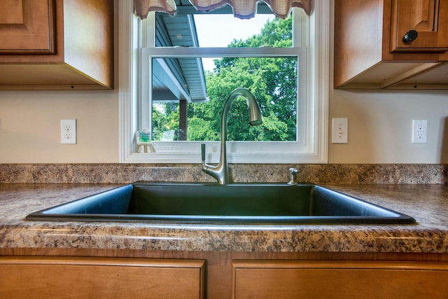 765 Huntley Ave, Logan, OH 43138 - kitchen view of a sink, brown cabinets, and dark countertops