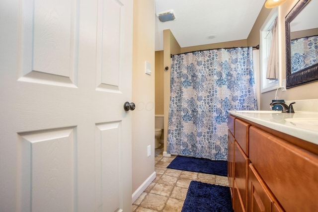 765 Huntley Ave, Logan, OH 43138 - full bath with toilet, double vanity, baseboards, stone finish flooring, and a shower with shower curtain