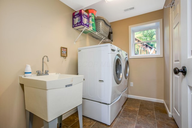 765 Huntley Ave, Logan, OH 43138 - laundry room with washing machine and dryer, baseboards, and dark stone finish floors