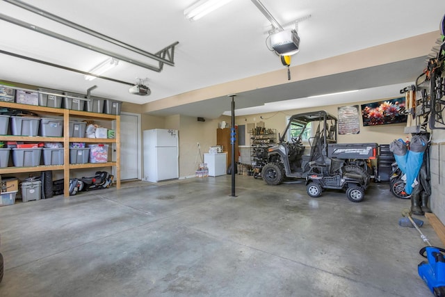 765 Huntley Ave, Logan, OH 43138 - garage with freestanding refrigerator, washer / clothes dryer, and a garage door opener