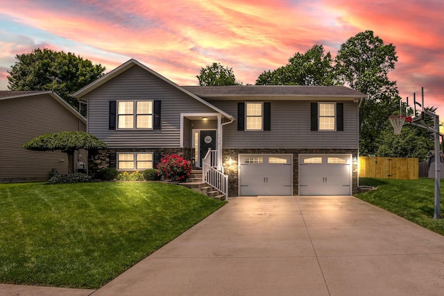 765 Huntley Ave, Logan, OH 43138 - bi-level home with stone siding, an attached garage, and concrete driveway
