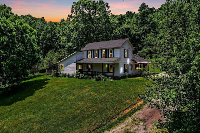26110 Big Pine Rd, Rockbridge, OH 43149 - farmhouse inspired home featuring a porch, a front yard, and a forest view