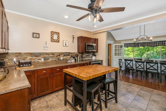 26110 Big Pine Rd, Rockbridge, OH 43149 - kitchen with stainless steel appliances, decorative backsplash, ceiling fan, a chandelier, and crown molding