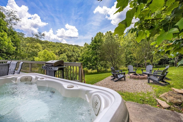 26110 Big Pine Rd, Rockbridge, OH 43149 - view of swimming pool featuring an outdoor fire pit, a hot tub, grilling area, a deck, and a lawn