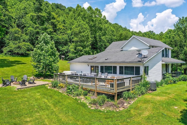 26110 Big Pine Rd, Rockbridge, OH 43149 - rear view of property featuring a fire pit, a deck, a lawn, and a wooded view