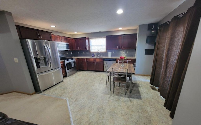 3230 Saint Bernard Cir, Columbus, OH 43232 - kitchen featuring appliances with stainless steel finishes, a sink, baseboards, decorative backsplash, and recessed lighting