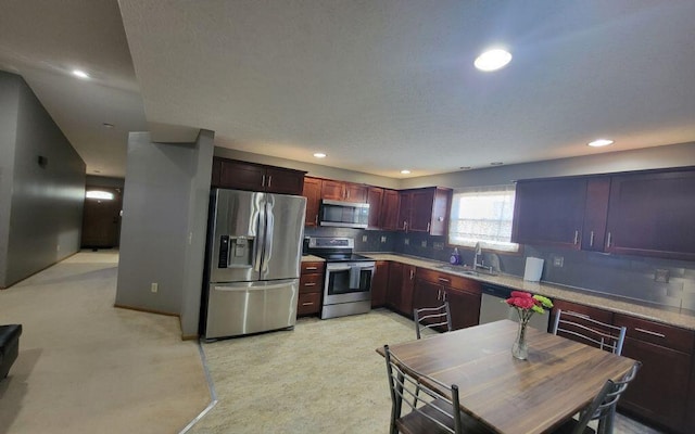 3230 Saint Bernard Cir, Columbus, OH 43232 - kitchen with appliances with stainless steel finishes, a sink, backsplash, recessed lighting, and light countertops