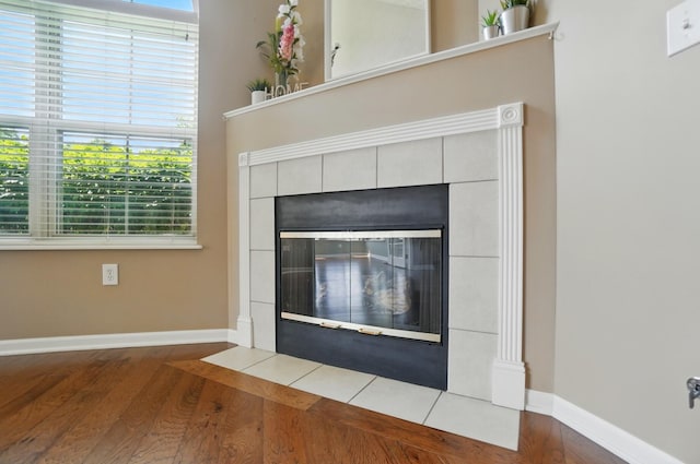4298 Bridgeside Pl, New Albany, OH 43054 - detailed view of wood finished floors, baseboards, and a tiled fireplace