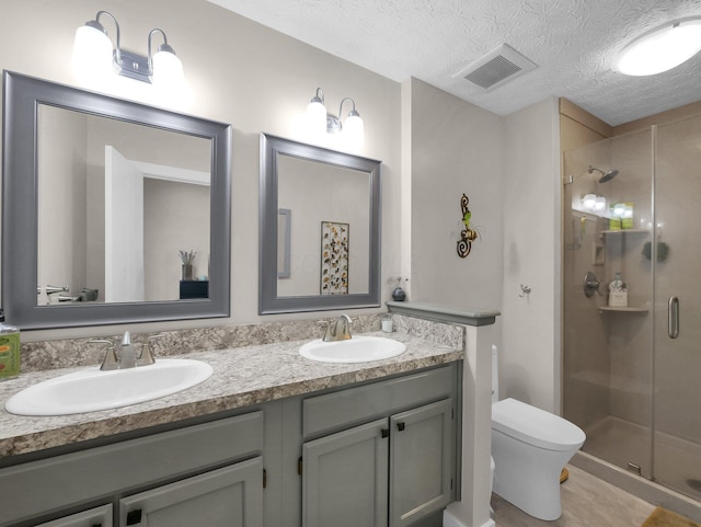 2908 Torrey Pines Dr, Pickerington, OH 43147 - bathroom with a stall shower, double vanity, toilet, and a textured ceiling
