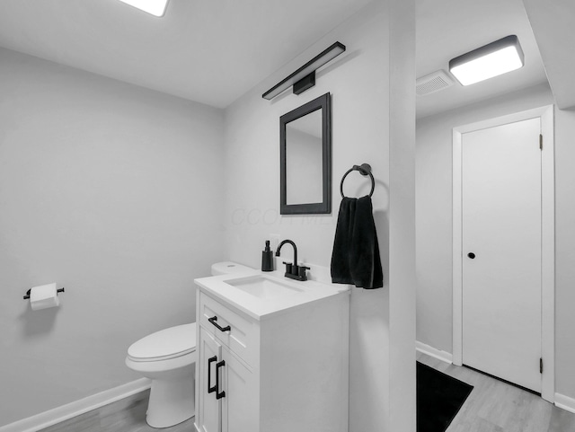 2908 Torrey Pines Dr, Pickerington, OH 43147 - half bathroom featuring vanity, toilet, wood finished floors, and baseboards