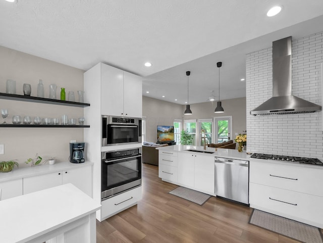 2908 Torrey Pines Dr, Pickerington, OH 43147 - kitchen featuring stainless steel dishwasher, wall chimney exhaust hood, cooktop, a sink, and white cabinets