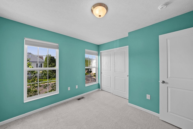 5801 Bridgehampton Dr, New Albany, OH 43054 - unfurnished bedroom with carpet floors, a closet, and a textured ceiling
