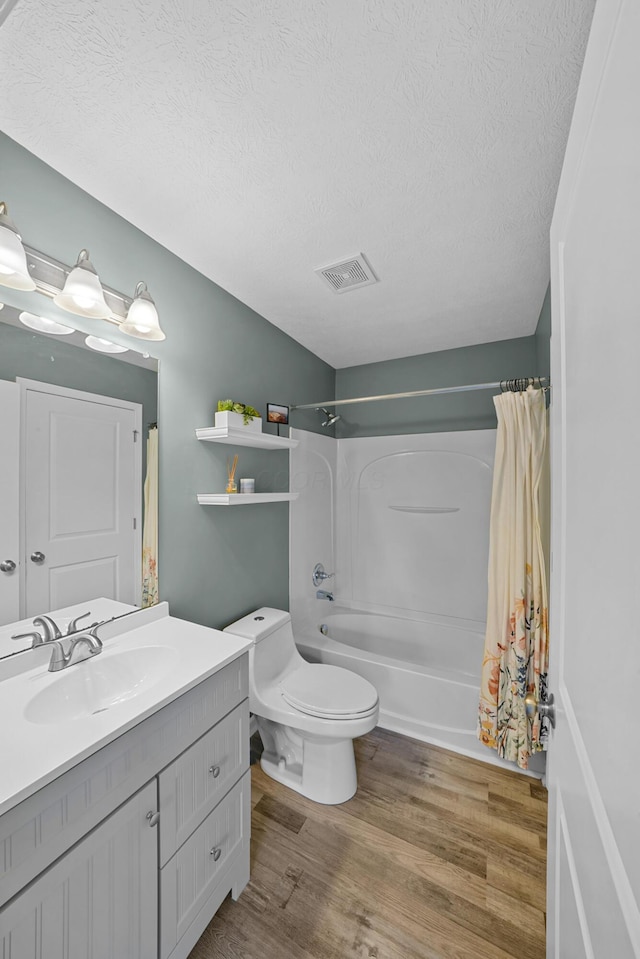 5801 Bridgehampton Dr, New Albany, OH 43054 - bathroom featuring vanity, shower / bath combo, wood finished floors, and a textured ceiling