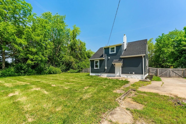 1271 Moundview Ave, Columbus, OH 43207 - rear view of house featuring a chimney, a gate, and roof with shingles