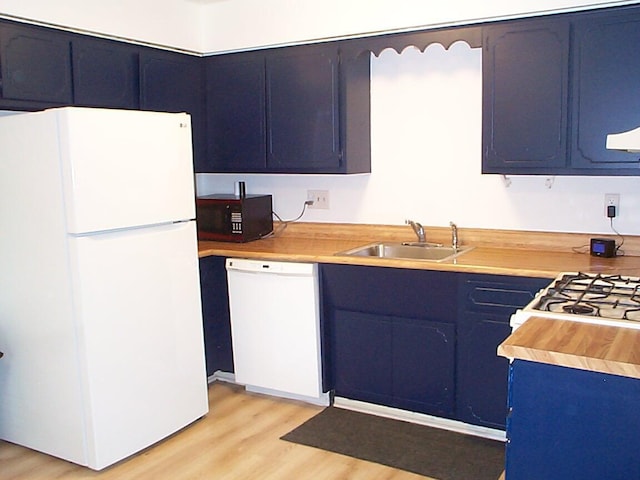 652 Olde Towne Ave Unit E, Columbus, OH 43214 - kitchen featuring white appliances, light wood-type flooring, a sink, and light countertops