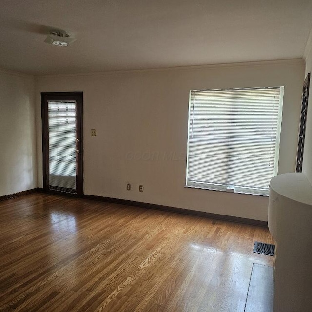 2325 E Livingston Ave, Columbus, OH 43209 - spare room with crown molding, wood finished floors, and baseboards