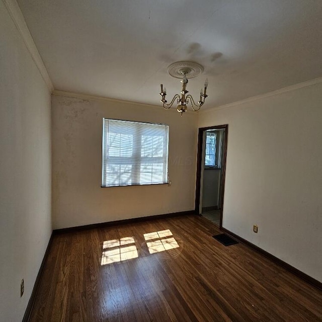 2325 E Livingston Ave, Columbus, OH 43209 - empty room featuring a chandelier, crown molding, wood finished floors, and baseboards