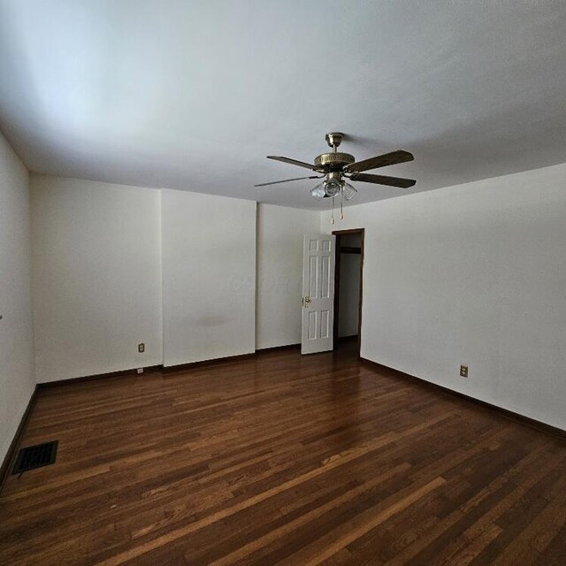 2325 E Livingston Ave, Columbus, OH 43209 - empty room with dark wood finished floors, a ceiling fan, and baseboards