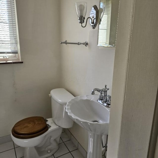 2325 E Livingston Ave, Columbus, OH 43209 - bathroom with toilet, tile patterned floors, healthy amount of natural light, and baseboards