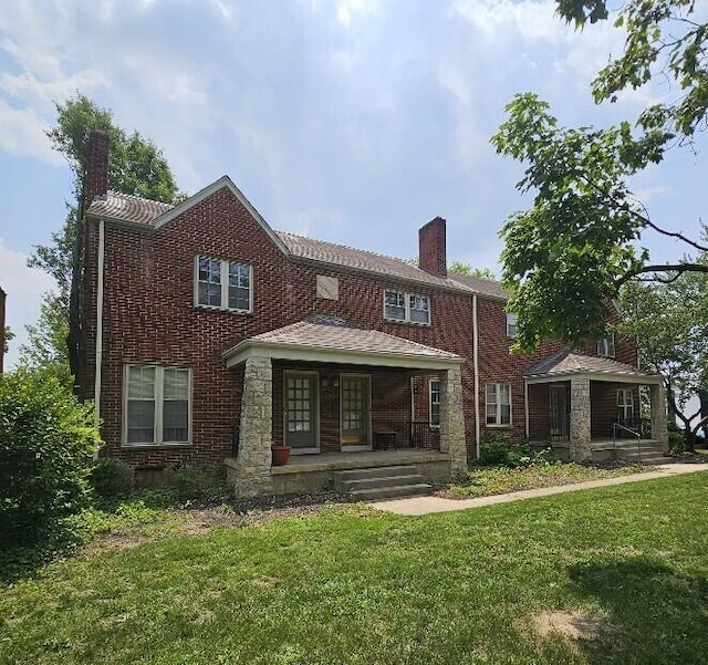 2325 E Livingston Ave, Columbus, OH 43209 - view of front of home featuring a porch, a chimney, a front lawn, and brick siding