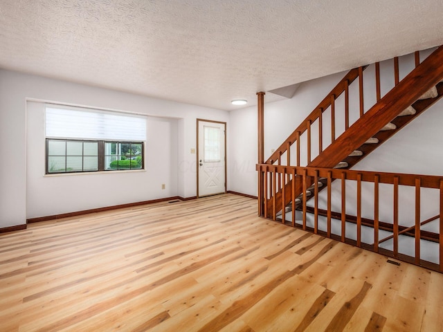 873 Soramill Ln Unit 4B, Columbus, OH 43085 - foyer entrance with wood finished floors, a textured ceiling, baseboards, and stairway