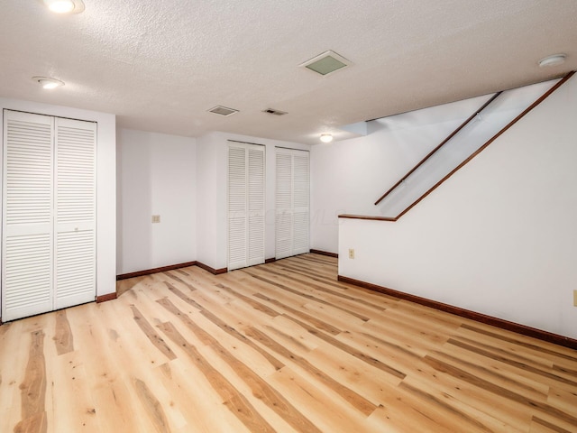 873 Soramill Ln Unit 4B, Columbus, OH 43085 - finished below grade area with light wood-type flooring, baseboards, and a textured ceiling