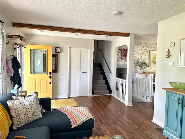 128 Ivy St, Newark, OH 43055 - living room with wood finished floors, stairway, baseboards, beam ceiling, and a textured ceiling