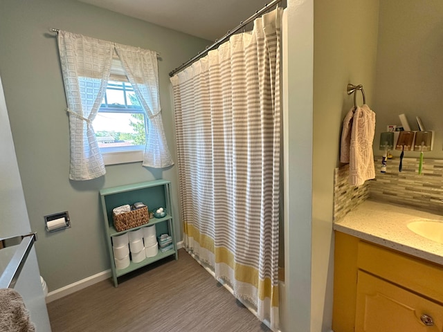 128 Ivy St, Newark, OH 43055 - bathroom with vanity, backsplash, wood finished floors, curtained shower, and baseboards