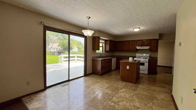 624 Village Park Dr, Powell, OH 43065 - kitchen featuring white range, under cabinet range hood, a textured ceiling, a kitchen island, and decorative light fixtures