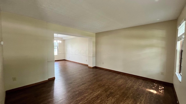 624 Village Park Dr, Powell, OH 43065 - spare room with dark wood finished floors, plenty of natural light, and a chandelier