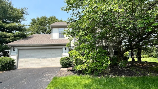 624 Village Park Dr, Powell, OH 43065 - view of property hidden behind natural elements featuring driveway and a shingled roof