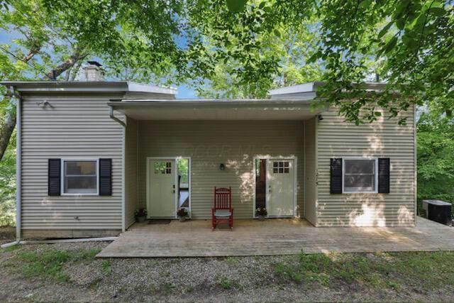 1275 Taos Ln, Sugar Grove, OH 43155 - rear view of property featuring a deck, central AC, and a chimney