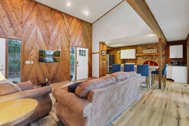 1275 Taos Ln, Sugar Grove, OH 43155 - living room with wood walls, light wood-style flooring, and vaulted ceiling