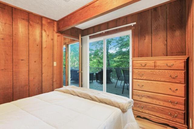 1275 Taos Ln, Sugar Grove, OH 43155 - bedroom with access to outside, wooden walls, and a textured ceiling