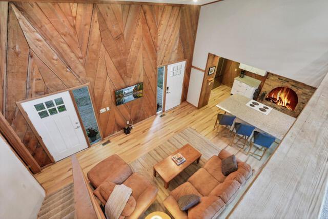 1275 Taos Ln, Sugar Grove, OH 43155 - living room featuring wooden walls, wood finished floors, and high vaulted ceiling