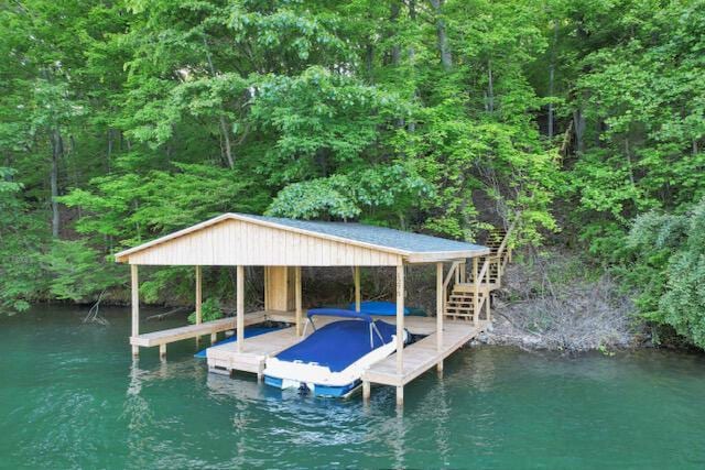 1275 Taos Ln, Sugar Grove, OH 43155 - dock with boat lift, a water view, a wooded view, and stairway