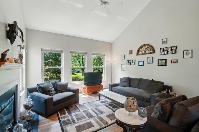 583 Marhurst Ct, Galloway, OH 43119 - living area featuring wood finished floors, high vaulted ceiling, ceiling fan, and a glass covered fireplace