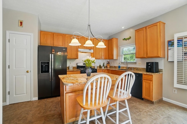583 Marhurst Ct, Galloway, OH 43119 - kitchen featuring fridge with ice dispenser, stainless steel gas stove, under cabinet range hood, black dishwasher, and a center island