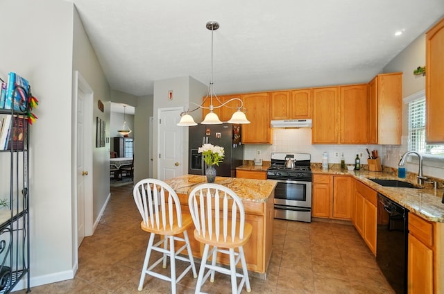 583 Marhurst Ct, Galloway, OH 43119 - kitchen featuring stainless steel appliances, a sink, a kitchen island, light stone counters, and under cabinet range hood