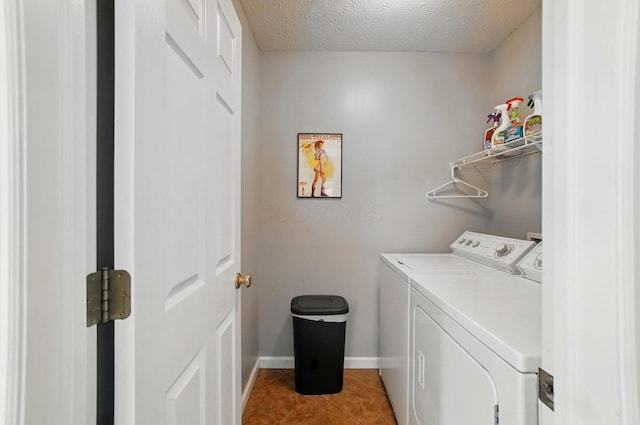 583 Marhurst Ct, Galloway, OH 43119 - laundry area featuring washer and dryer, light tile patterned floors, baseboards, and a textured ceiling